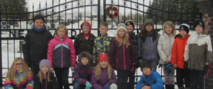 Students standing in front of grave yard